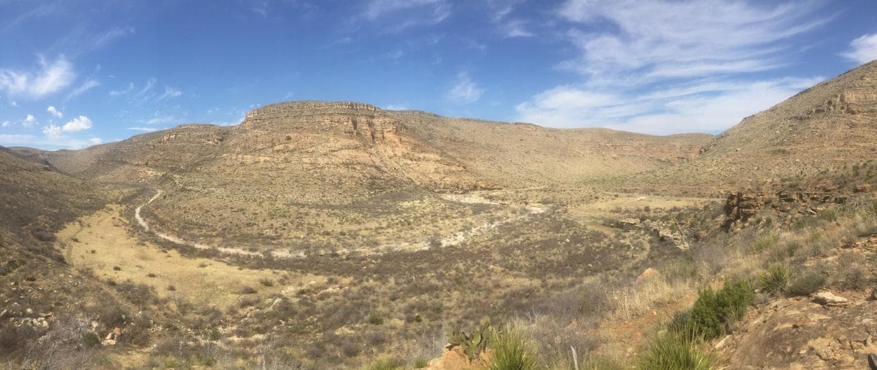 Limestone benches above a dry grassland canyon floor